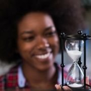 young woman at office looking at sand clock PPH7Z8K 2 1 scaled 2